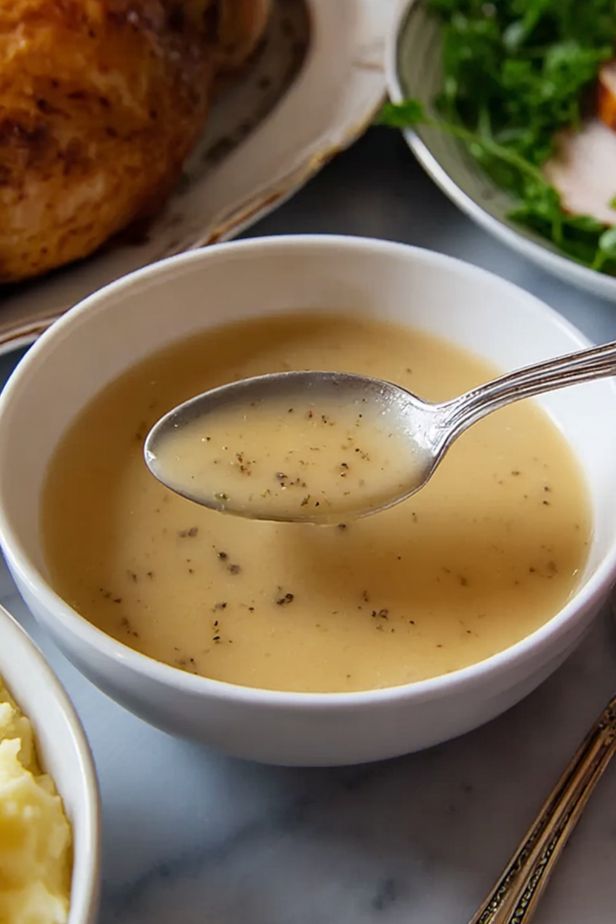 Perfect Turkey Gravy poured over mashed potatoes
