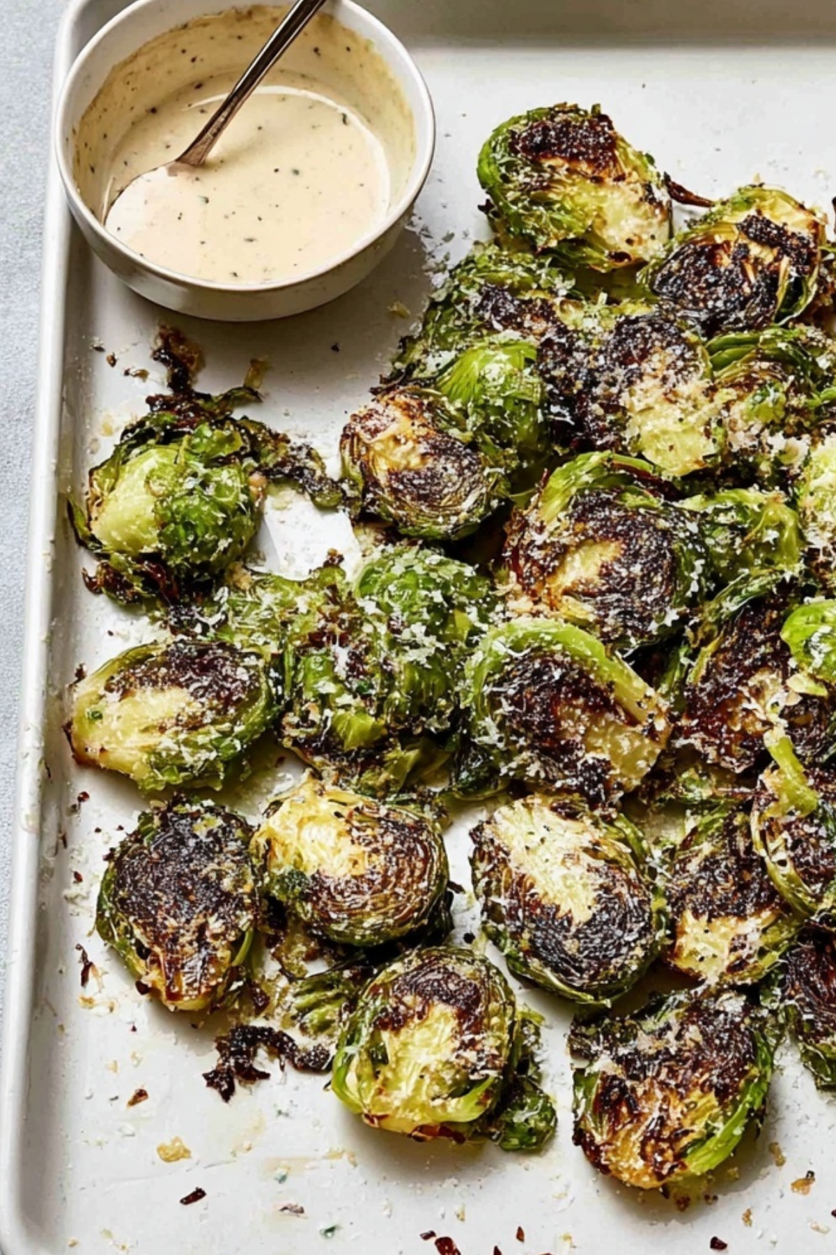 Roasted Smashed Brussels Sprouts with Parmesan on a baking sheet