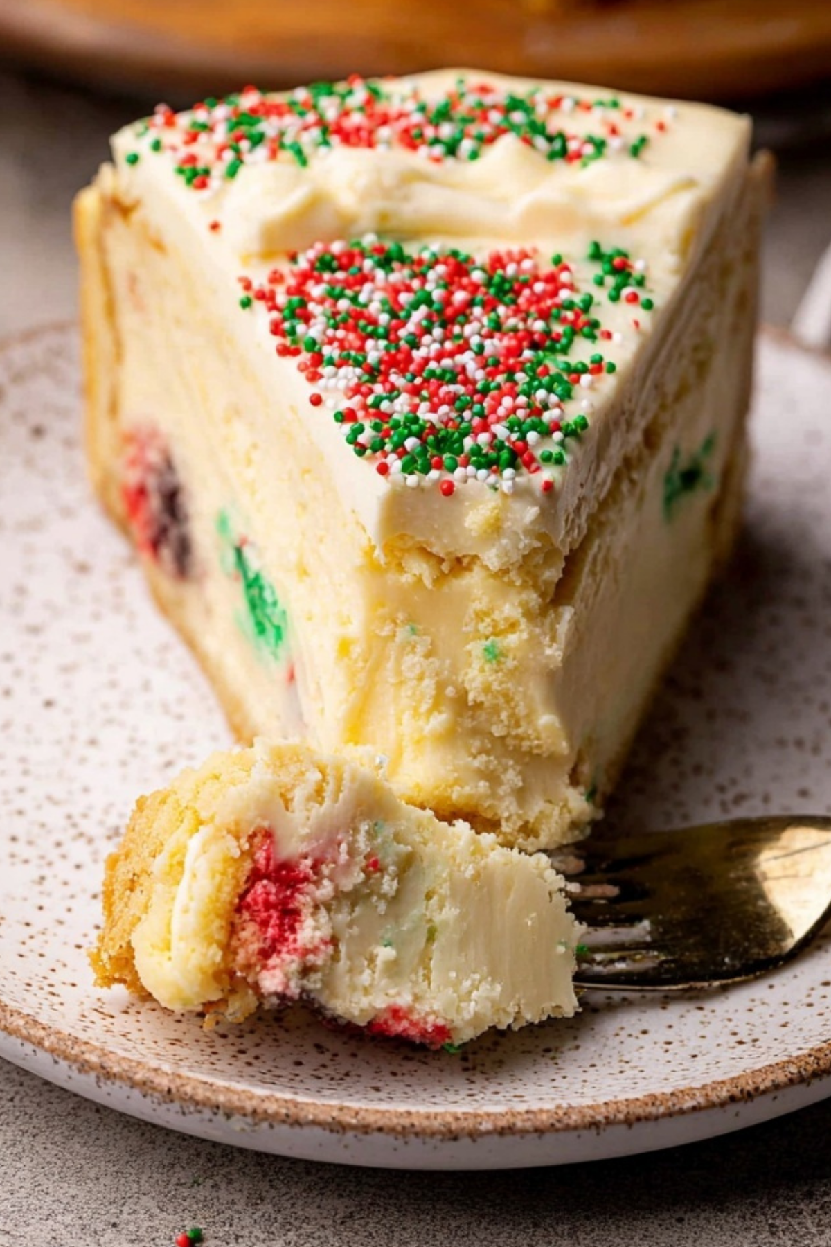 Sugar Cookie Cheesecake with white chocolate ganache and festive sprinkles