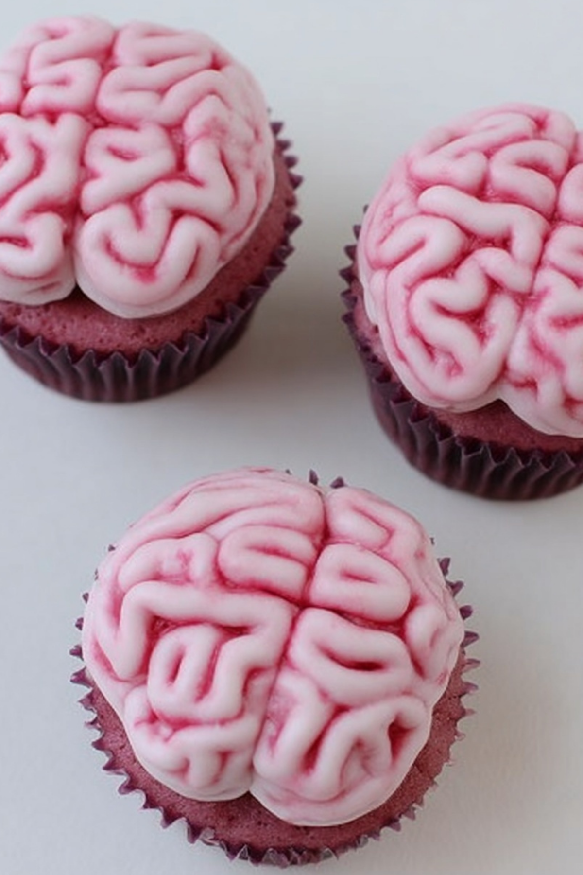Zombie Brain Cupcakes with natural frosting and beet-colored cake