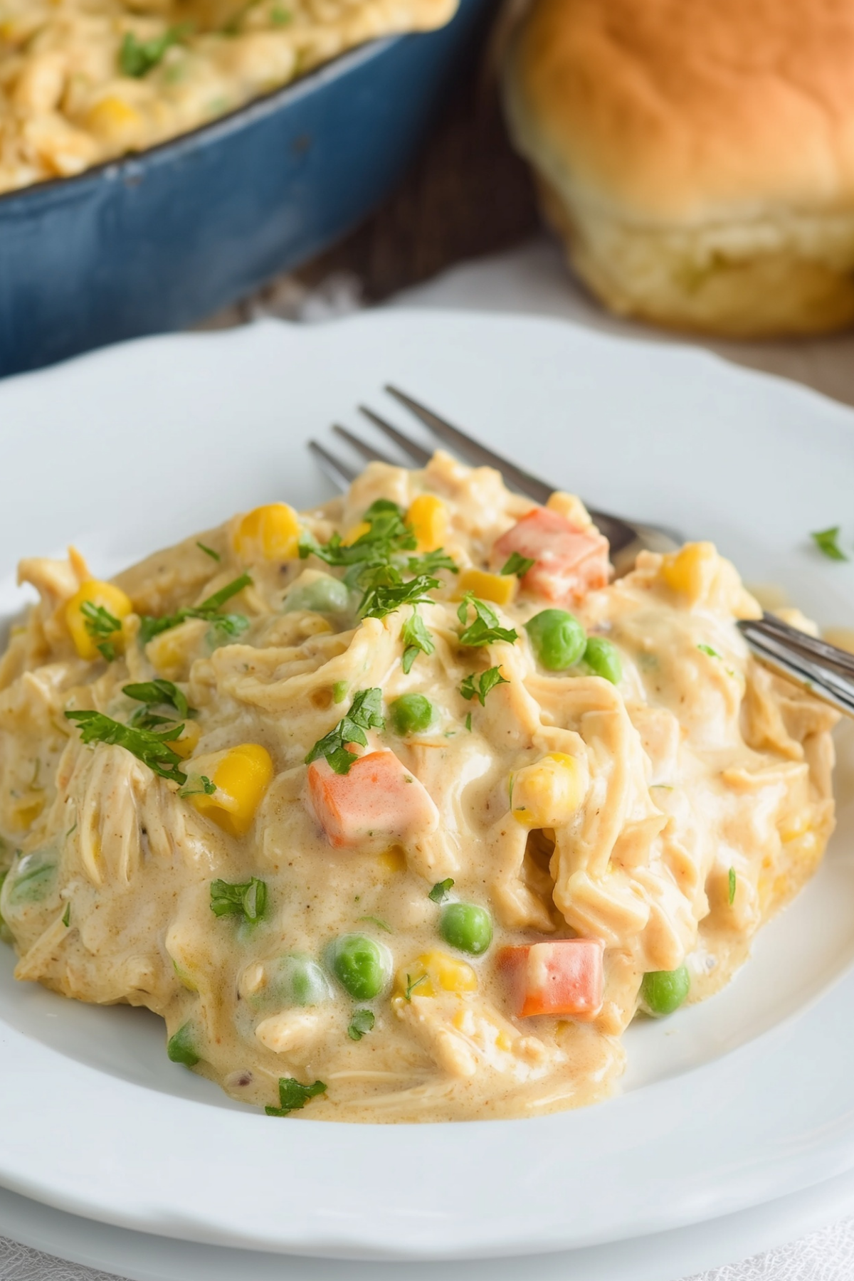 Chicken pot pie casserole with a flaky biscuit topping