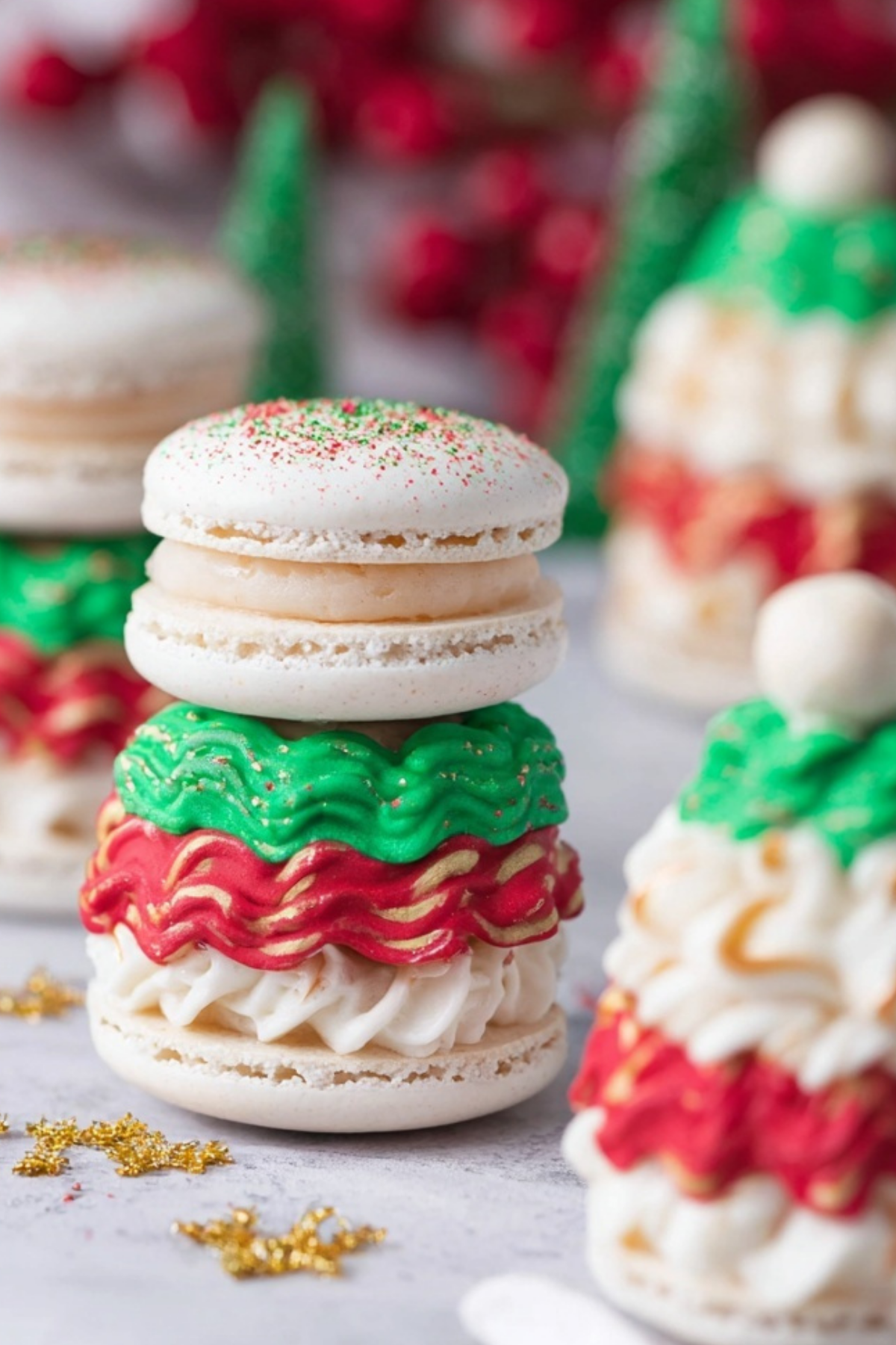 Christmas Tree Cake Macarons decorated with white chocolate and green sprinkles