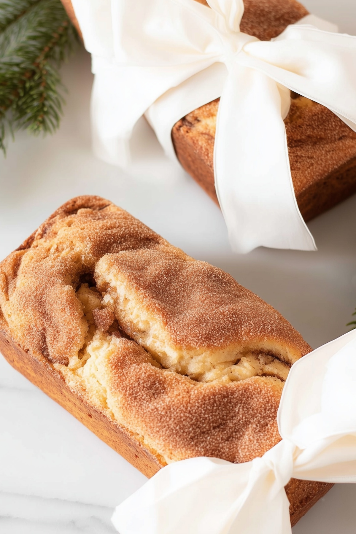 Cinnamon bread loaf freshly baked with a golden crust and a swirl of cinnamon