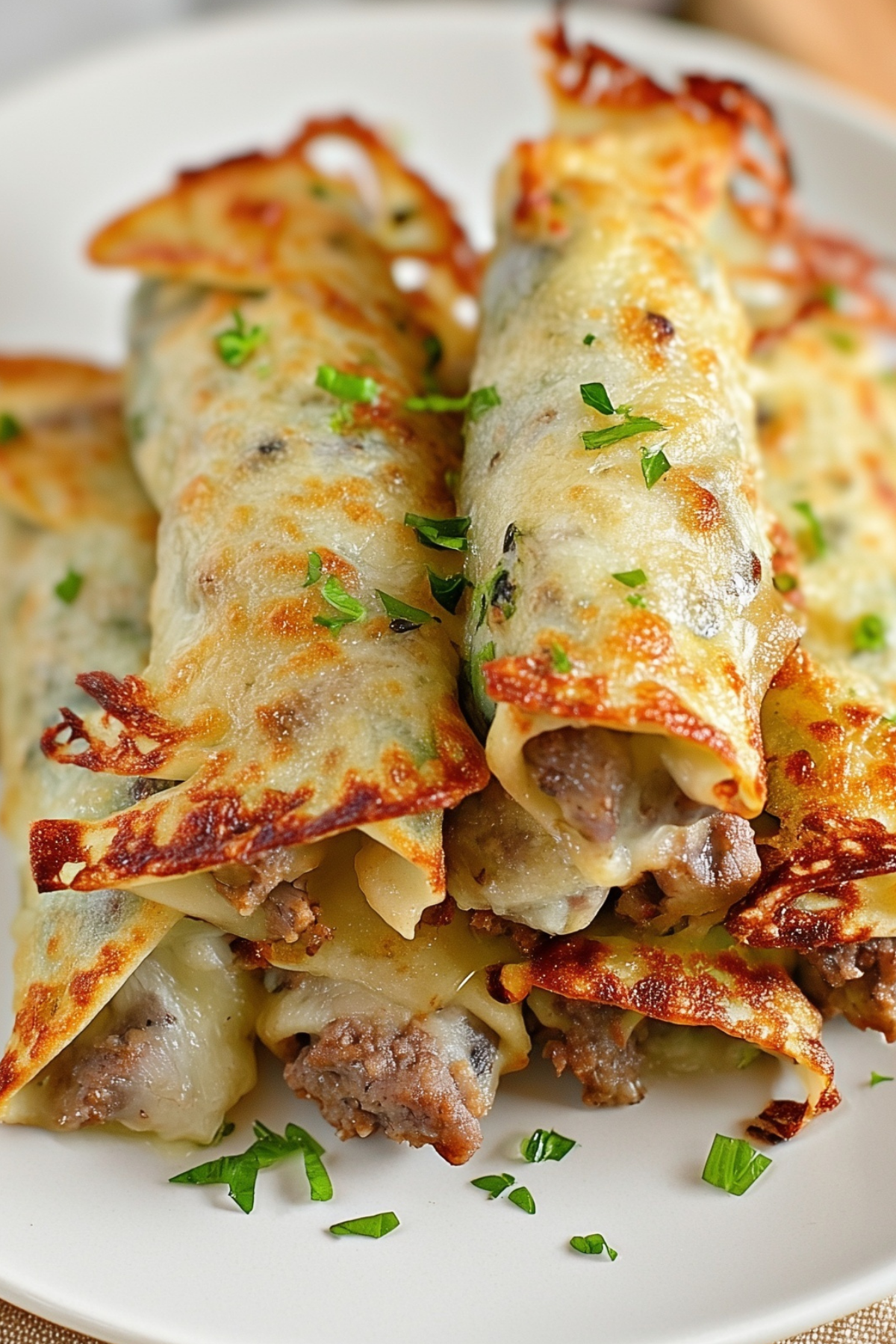 Keto Philly Cheesesteak Roll Ups served on a plate with melted cheese