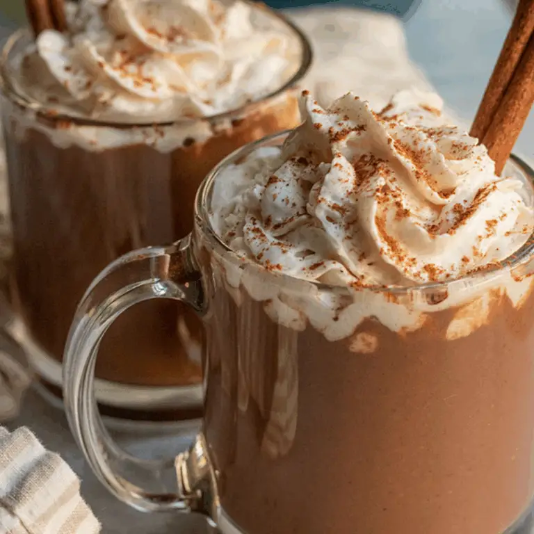 Pumpkin Spice Hot Chocolate in a cozy mug with whipped cream and cinnamon