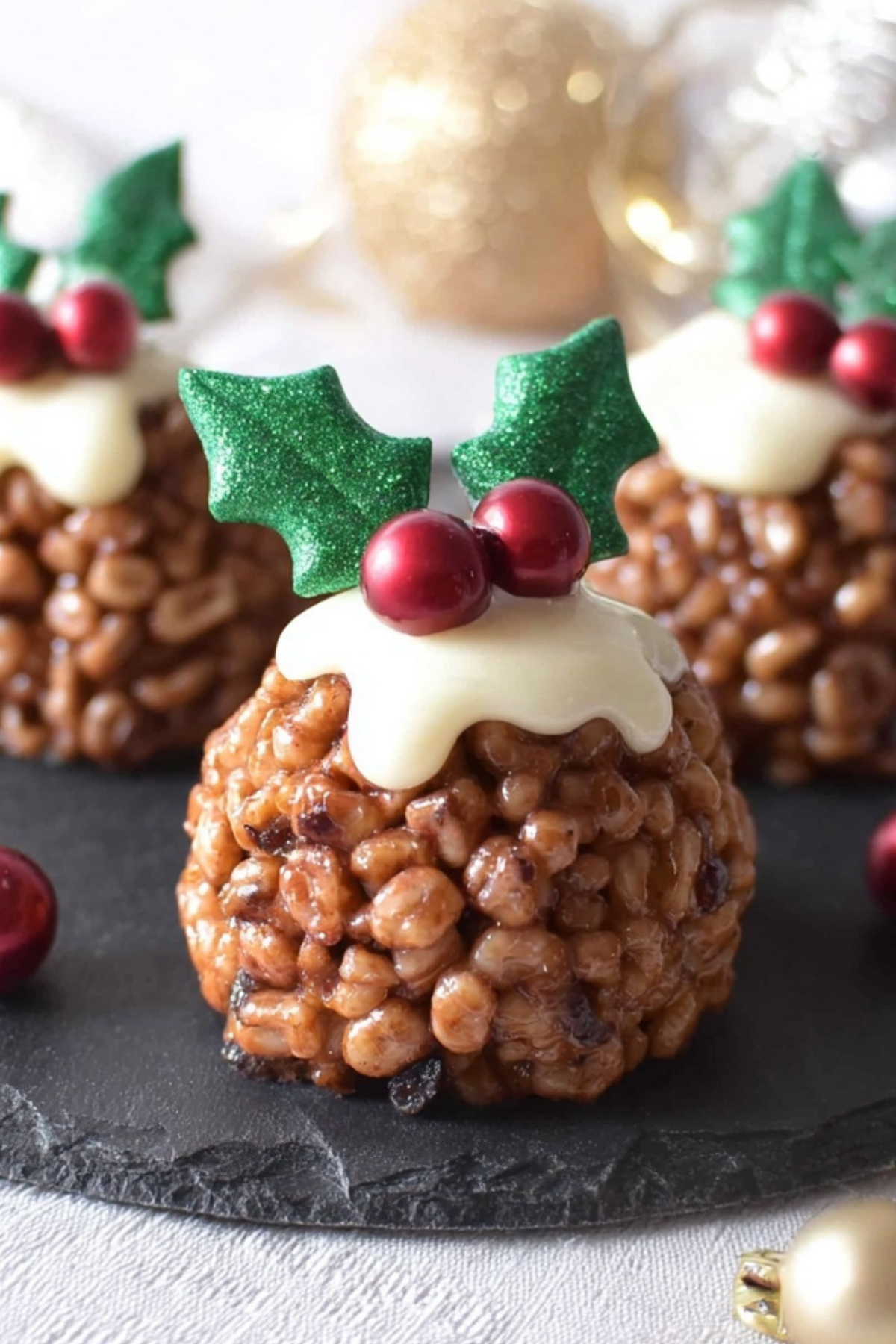 Rice Krispie Christmas Puddings decorated with white chocolate and holly