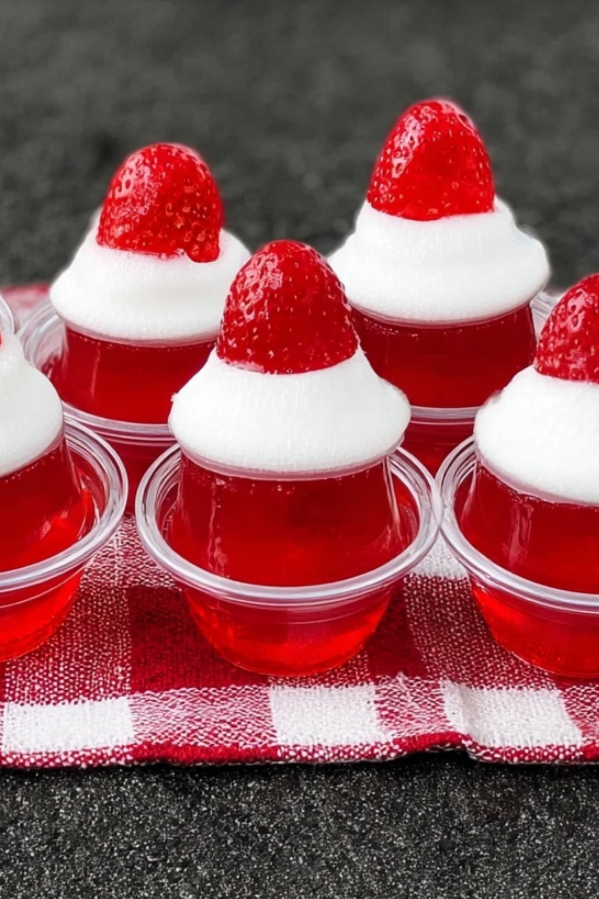 Santa Hat Jello Shots served with whipped cream and strawberries for a festive holiday treat