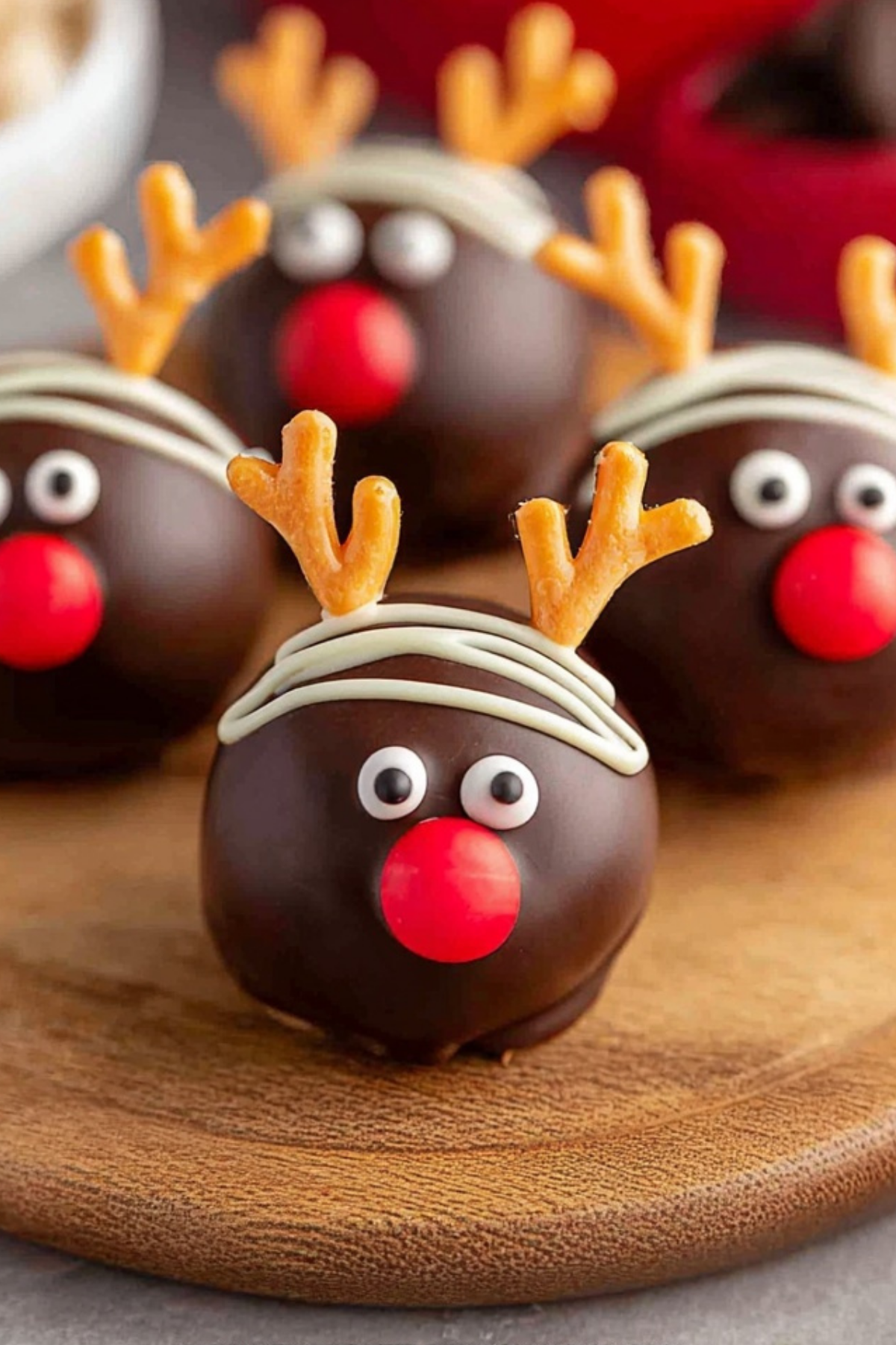 Reindeer Oreo balls decorated with pretzel antlers and red hot noses