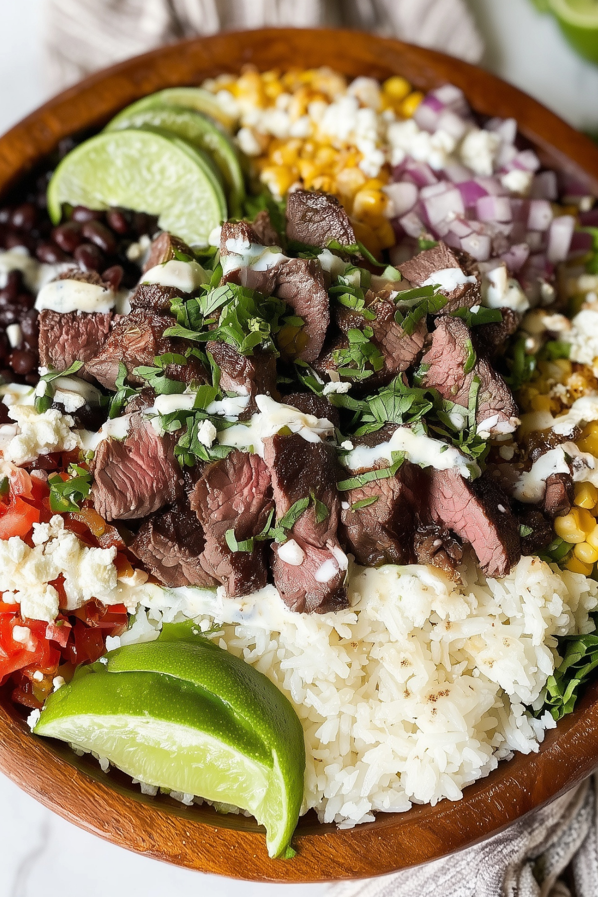 cilantro lime steak bowls recipe with grilled steak, rice, and avocado