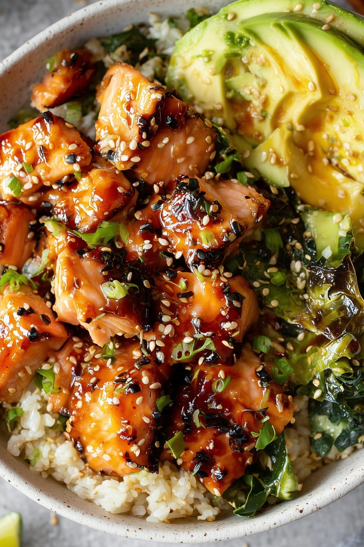 Honey Glazed Salmon Bowl served with fresh avocado, cucumber, and a creamy paprika mayo drizzle