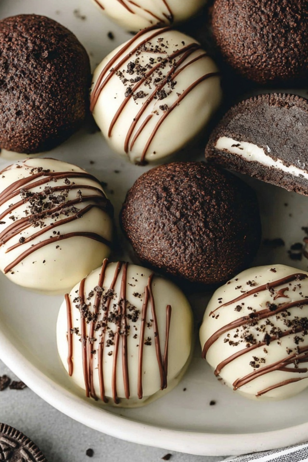 No Bake Oreo Balls coated in chocolate and topped with cookie crumbs