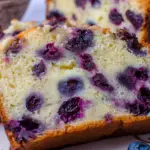 Blueberry Cream Cheese Loaf sliced on a serving plate