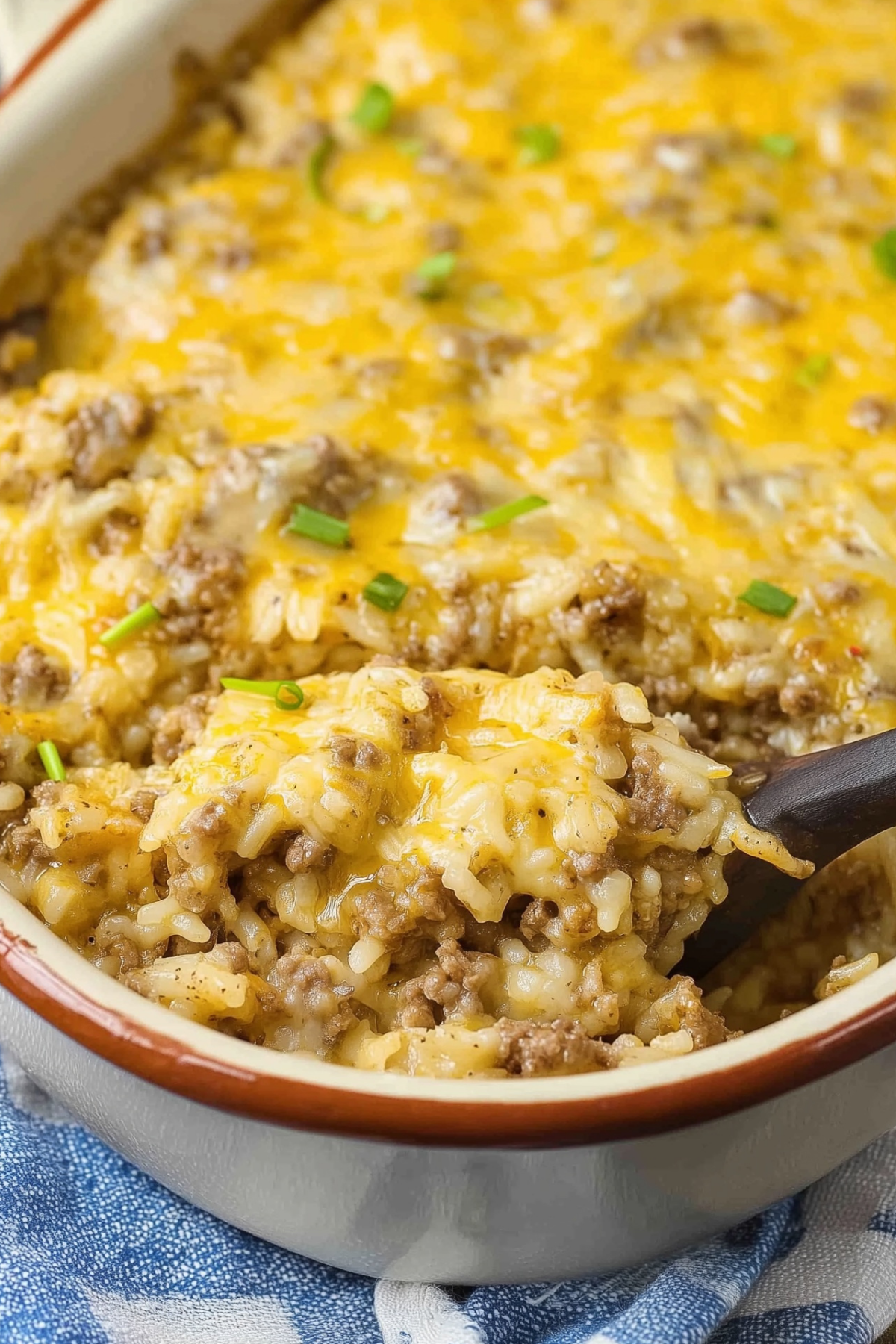 Cheesy Ground Beef and Rice Casserole in a baking dish topped with melted cheese