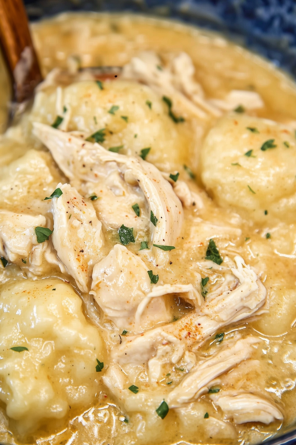 Crock Pot Chicken and Dumplings served in a bowl with fluffy biscuit dumplings