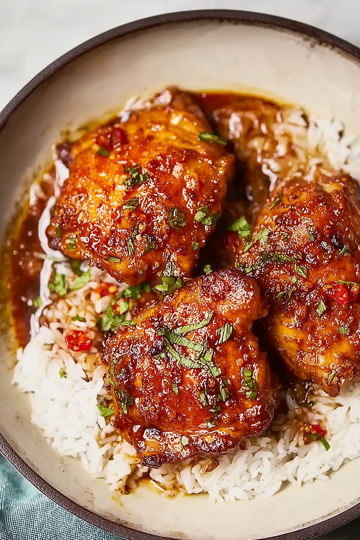 Honey Garlic Chicken Thighs in skillet with sticky glaze