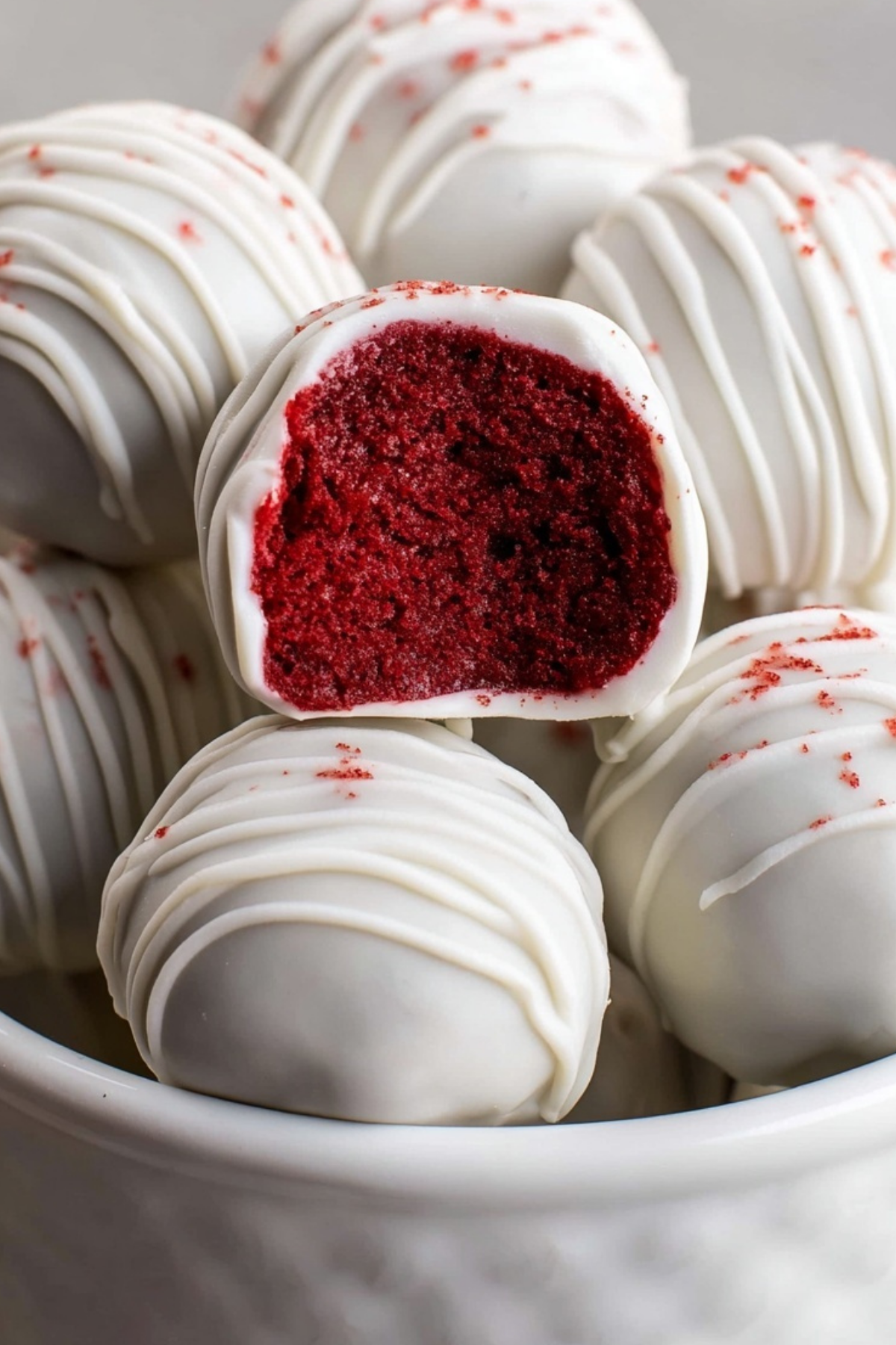 Red Velvet Cake Pops on a tray with a smooth white chocolate coating