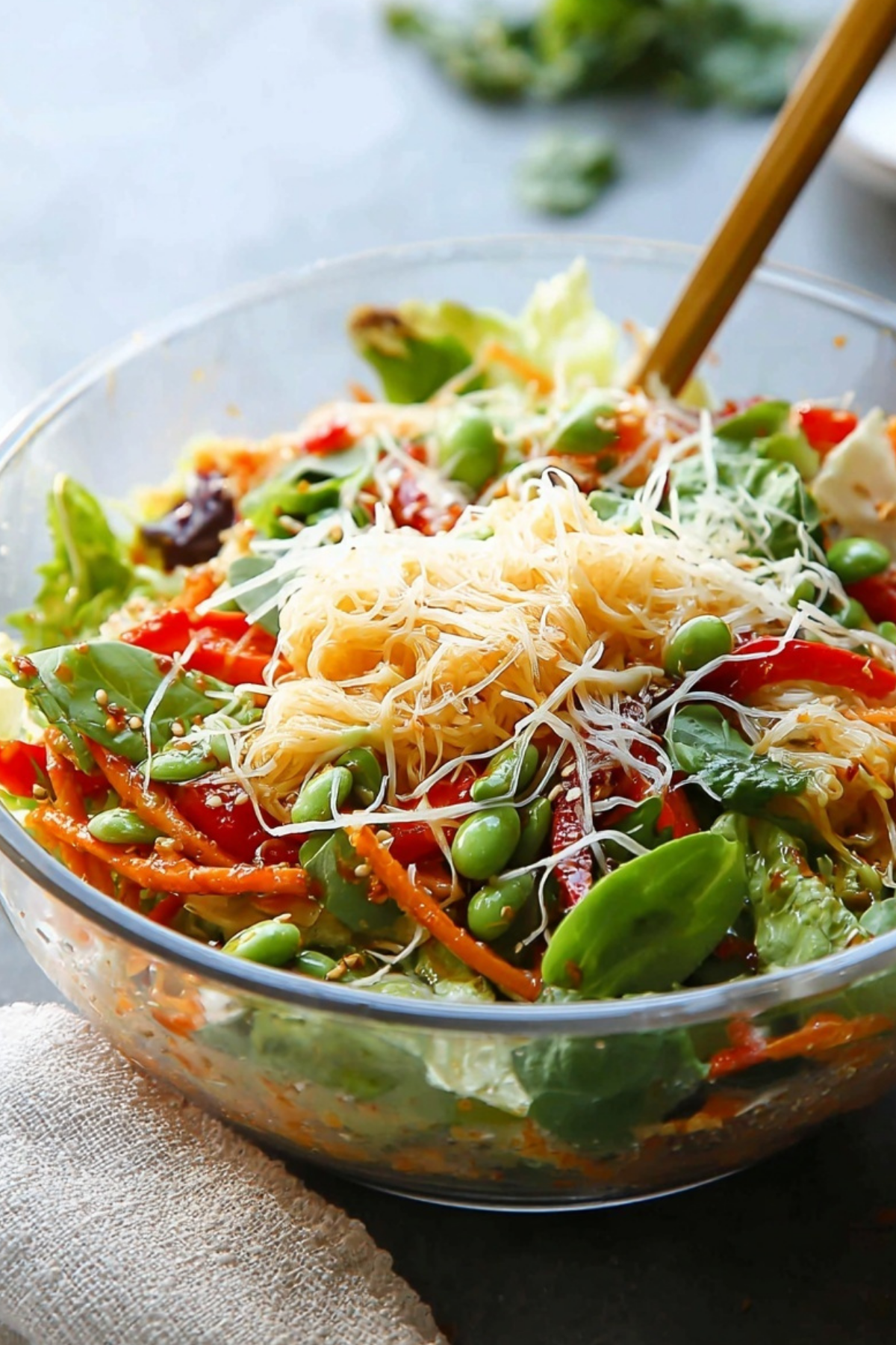 Spring Roll Salad with Spicy Ginger Dressing in a bowl with fresh vegetables and herbs