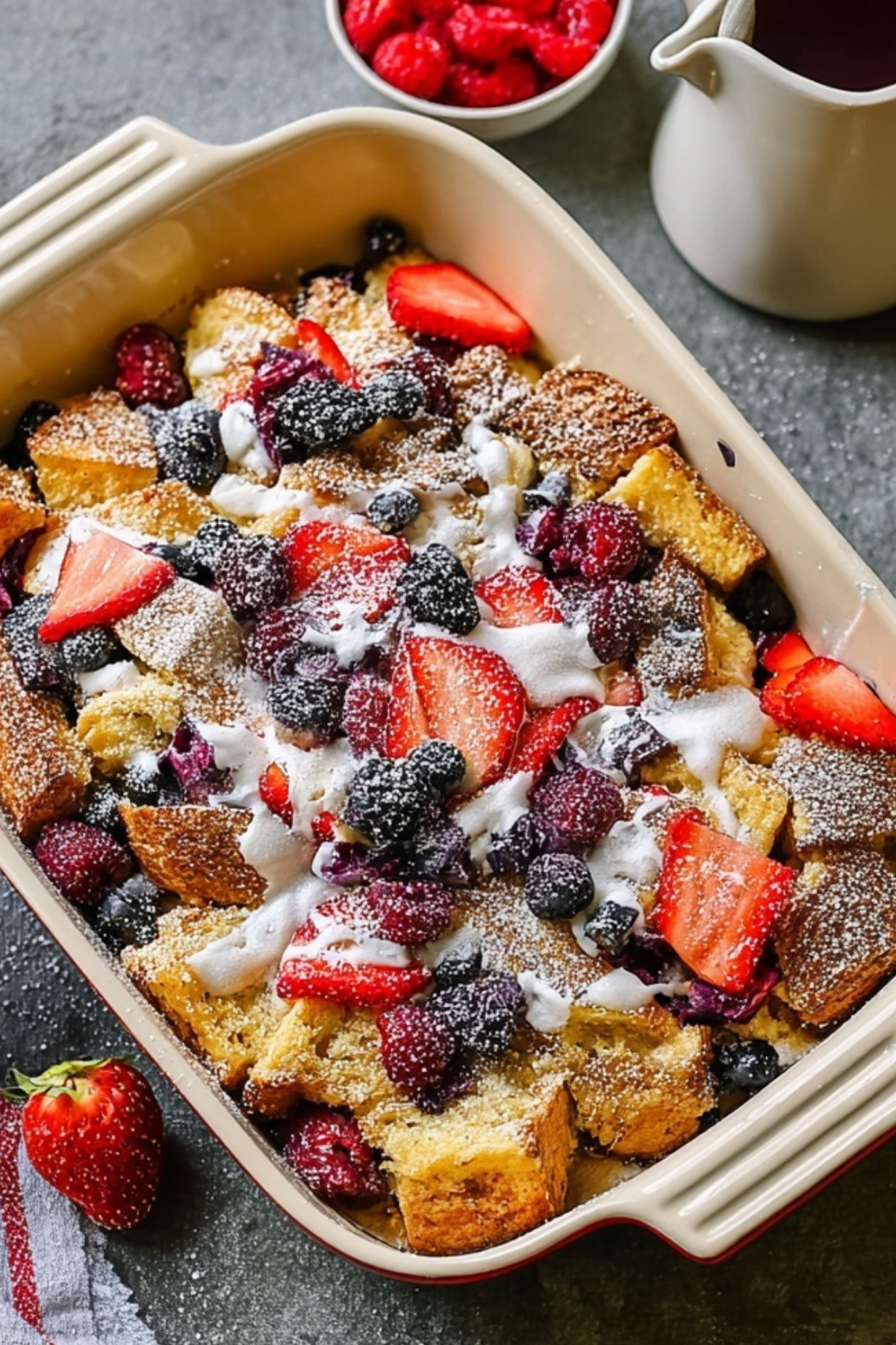 Berries and Cream French Toast Casserole with fresh berries and powdered sugar
