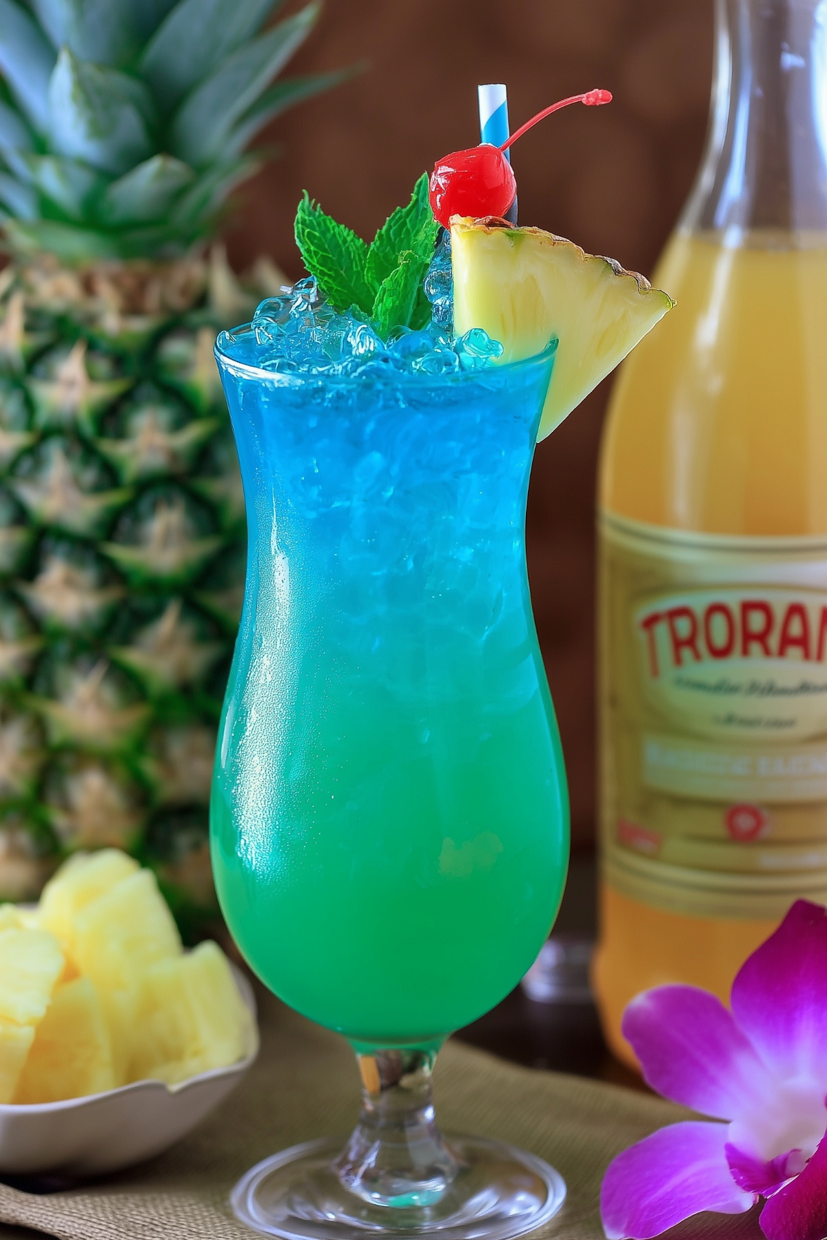 Blue Hawaii mocktail served with pineapple and cherry garnish