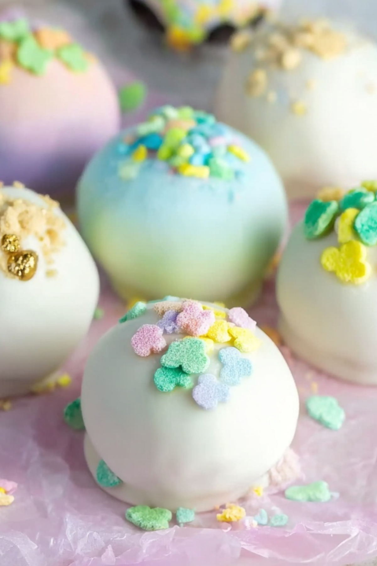 Lucky Charms Oreo Truffles coated in white chocolate with cereal marshmallows on top