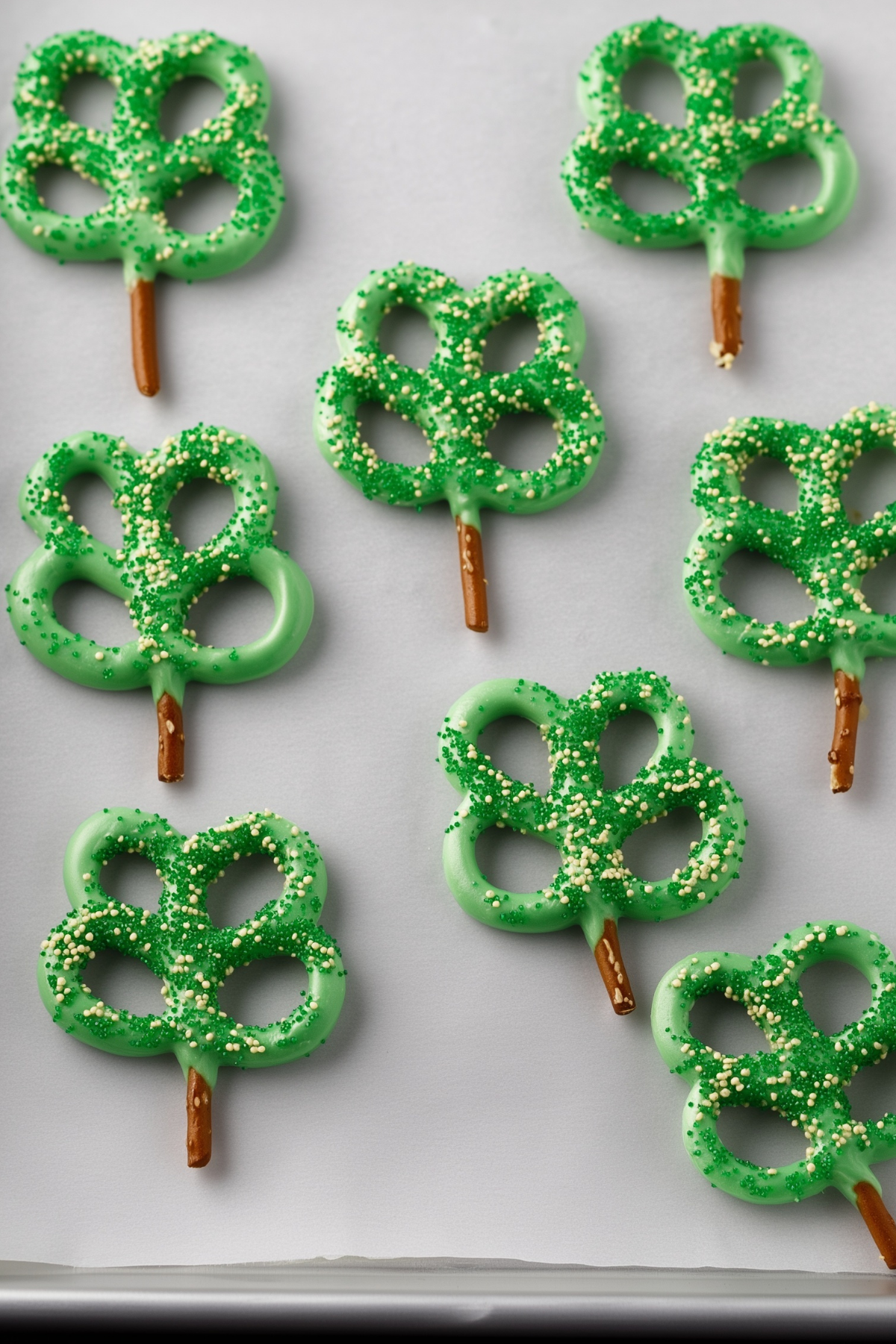 Pretzel Shamrocks made with green candy melts and pretzel twists on sticks