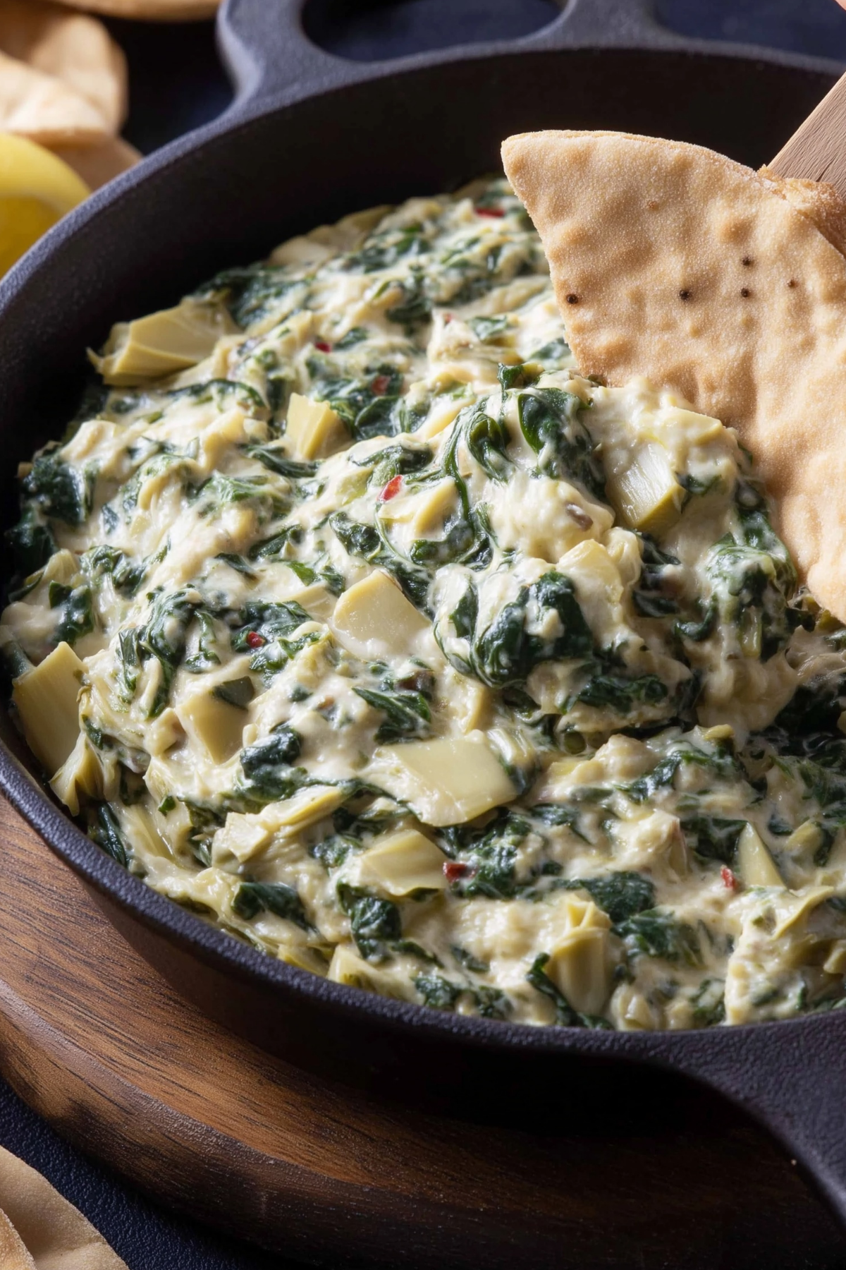 Creamy vegan Spinach Artichoke Dip served warm with bread