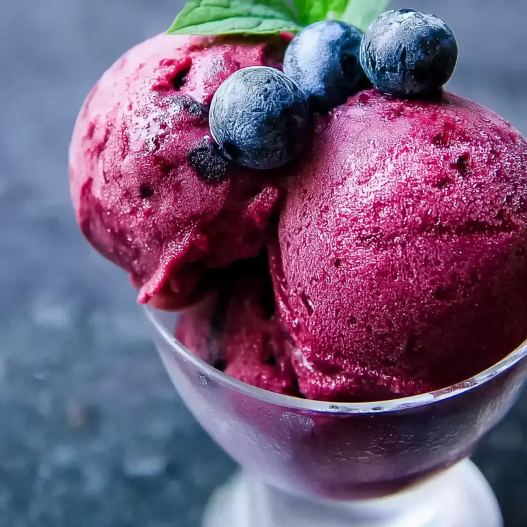 Homemade Blueberry Sorbet in a bowl with fresh blueberries