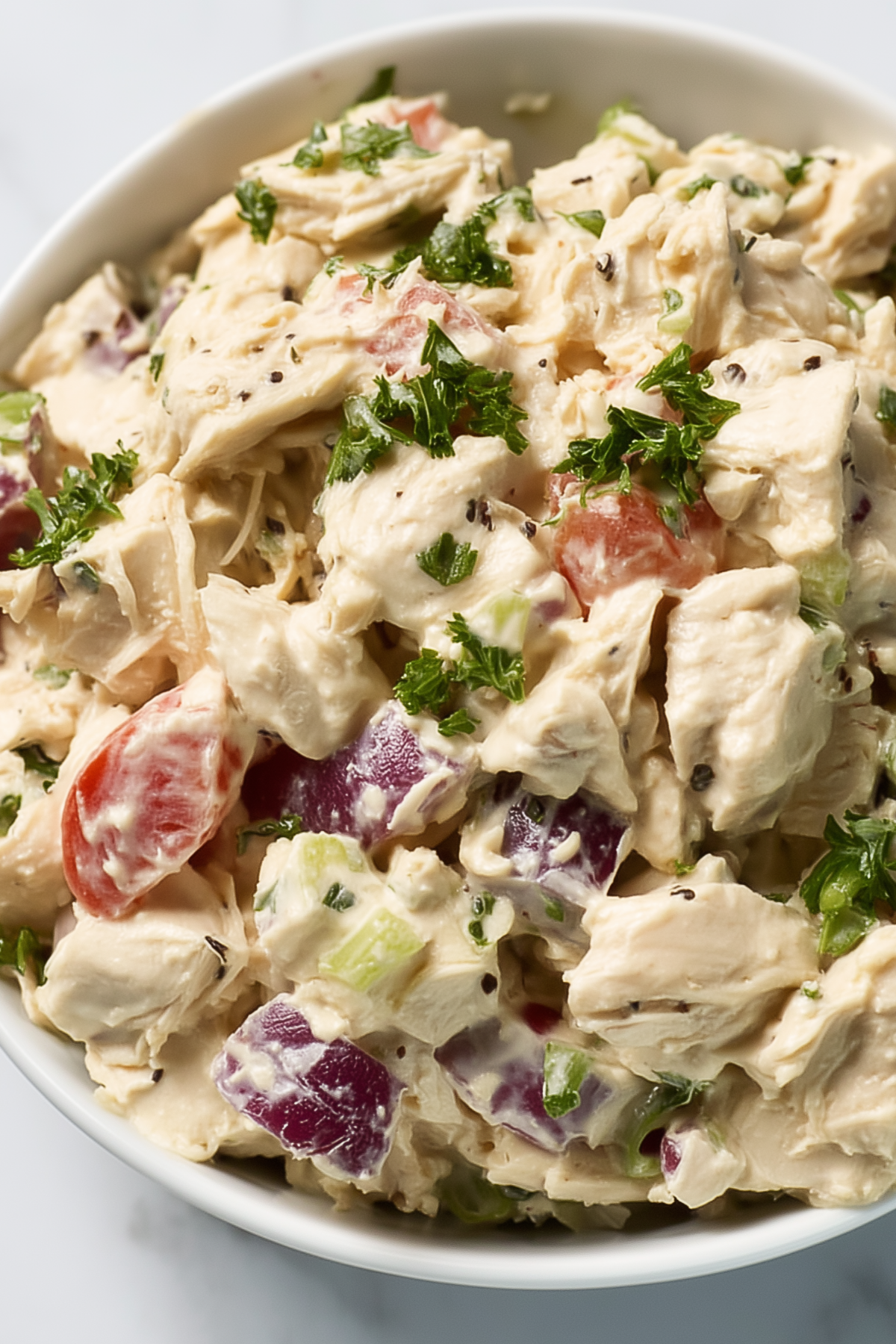 Chicken Salad served in a bowl with creamy dressing and fresh herbs