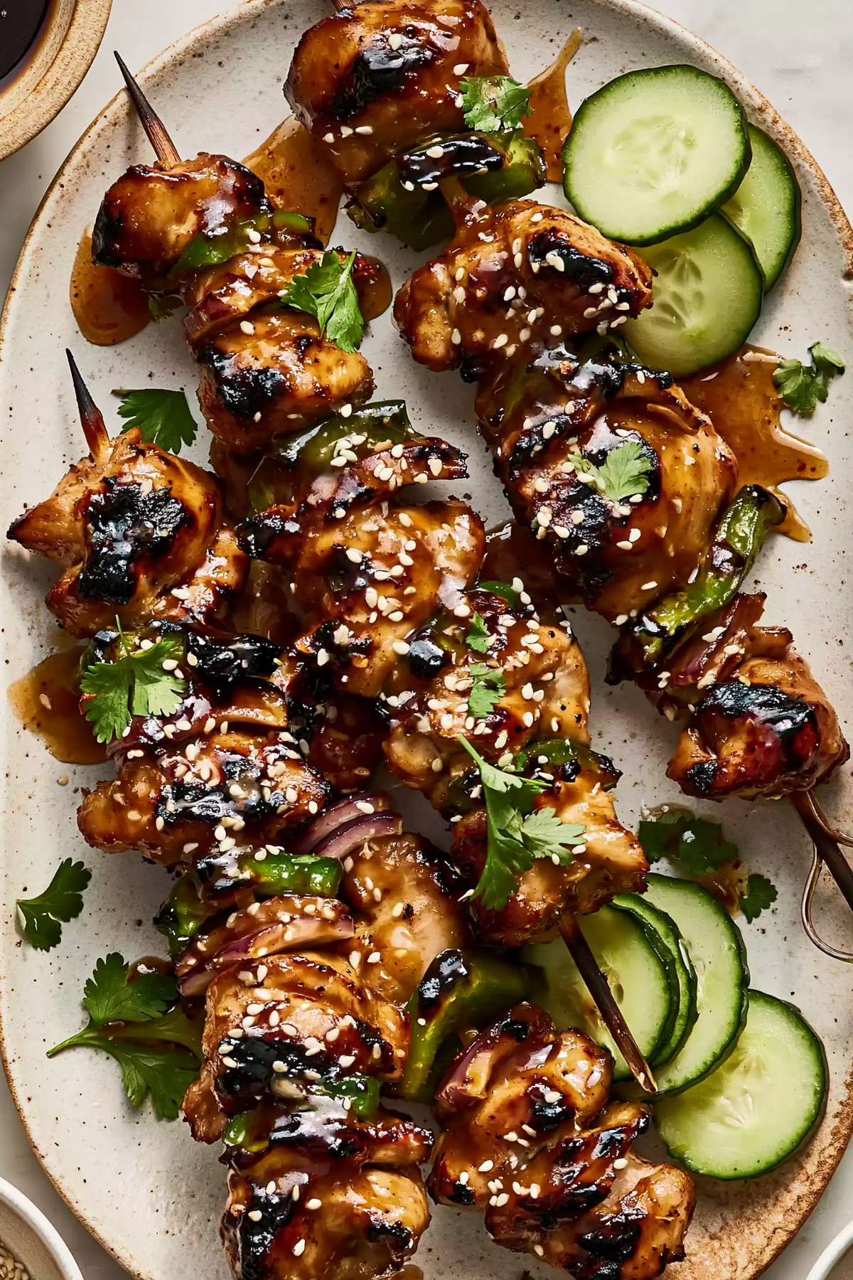Honey Garlic Asian Chicken Kabobs served with sesame seeds and green onions