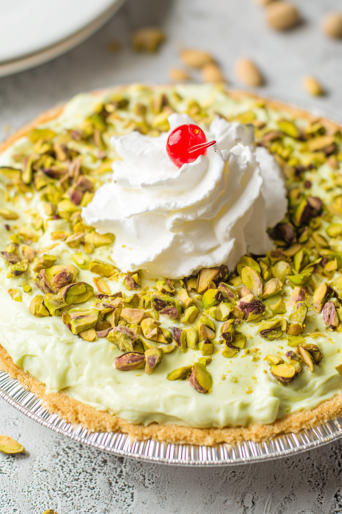 Delicious Pistachio Pie topped with whipped cream and chopped pistachios