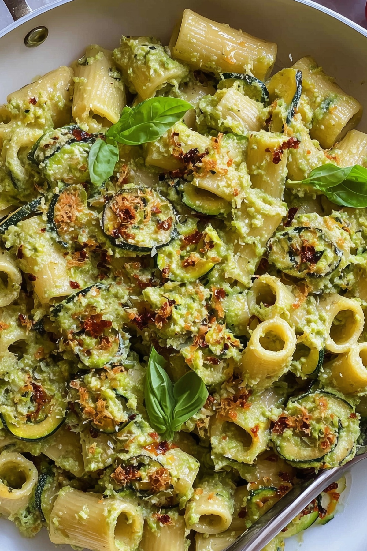Fresh homemade zucchini pasta served with herbs and creamy zucchini sauce